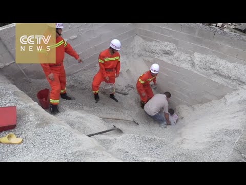 firefighters rescue workers buried in giant sandpit