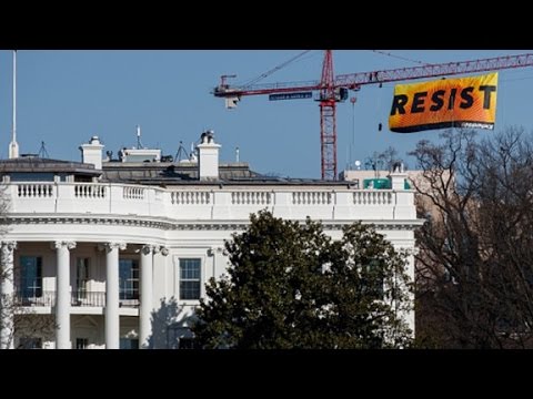 activists scale crane