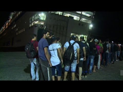 syrian refugees register on greek ship docked at kos