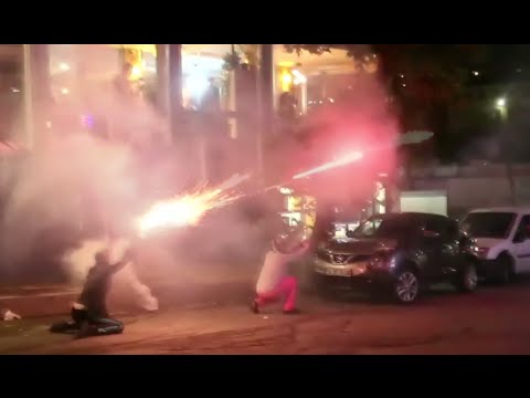 protesters throw molotov cocktails towards cops