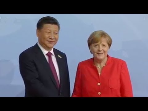 german chancellor angela merkel greets