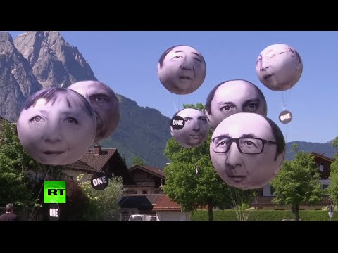 balloons with summit leaders displayed in protest