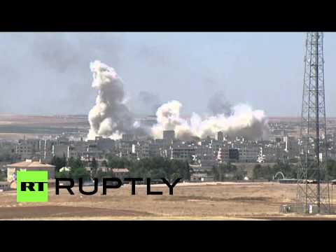 huge plumes of smoke rise in the sky above kobani