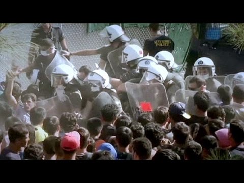 riot police clash with migrants